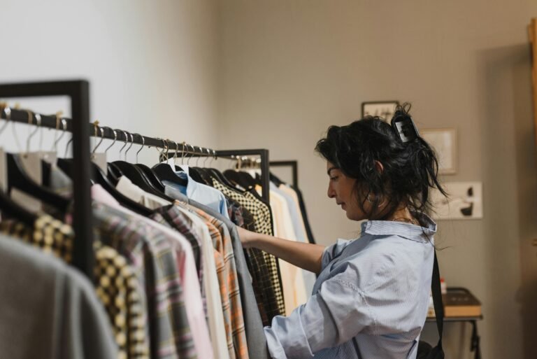 Woman selecting women’s western wear from a clothing rack in a boutique